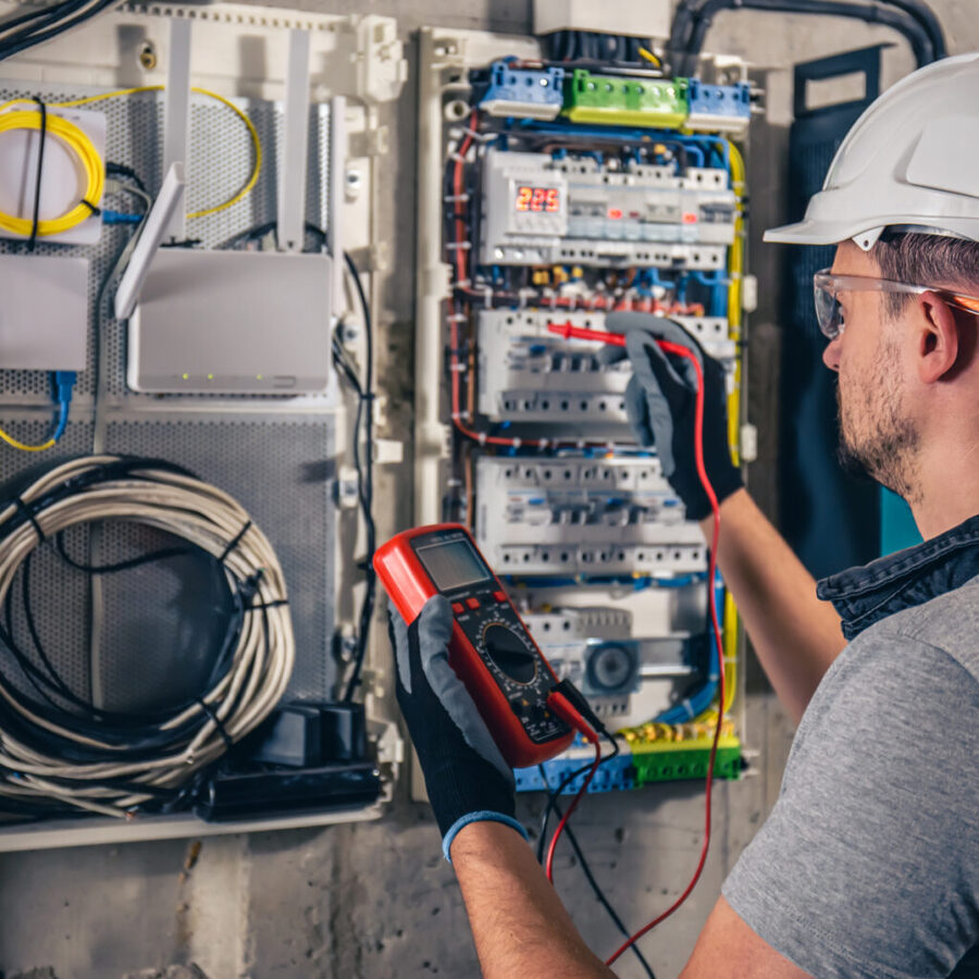 Electrician testing a distribution panel